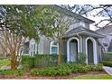 Two-story home with arched entryways, manicured landscaping, and a welcoming facade at 8135 Nw 26Th Lane Rd, Ocala, FL 34482