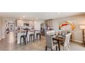 Open-concept kitchen and dining area with stainless steel appliances and modern countertops at 8502 Las Palmas Way, Wildwood, FL 34785