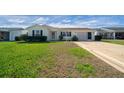 Charming single-story home featuring a well-maintained lawn and attached two-car garage at 912 Chula Ct, Lady Lake, FL 32159