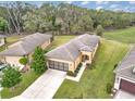 Aerial view of a well-maintained home with lush green lawn and mature landscaping in a quiet neighborhood at 9697 Sw 63Rd Loop, Ocala, FL 34481