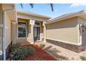 Inviting front entryway showcasing brick pavers, stone accents, and a transom window above the front door at 10138 Lake Miona Way, Oxford, FL 34484