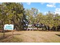 Lake Otting community sign with mature trees and a view of the lake at 10215 Sw 134Th Ct, Dunnellon, FL 34432