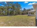 Expansive backyard perfect for outdoor activities and relaxation, surrounded by lush trees at 10657 Sw 110Th Ct, Dunnellon, FL 34432