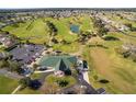 Aerial view of golf community with lush fairways and a clubhouse at 1921 Nw 50Th Cir, Ocala, FL 34482