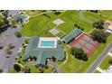 Aerial view of community amenities including a pool, tennis courts, and shuffleboard courts at 1921 Nw 50Th Cir, Ocala, FL 34482