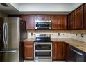 Well-equipped kitchen featuring stainless steel appliances, granite countertops, and stylish tile backsplash at 20260 Sw 95Th St, Dunnellon, FL 34431