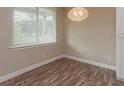 Cozy bedroom featuring wood-look floors, blinds and neutral paint at 2259 Nw 2Nd Ave, Ocala, FL 34475