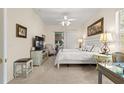 Well-lit main bedroom with a ceiling fan, sitting area, desk and a view to the bathroom at 2310 Nw 59Th Ave, Ocala, FL 34482