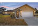 Lovely home featuring a stone entryway, attached garage, and a manicured front lawn at 2620 Sw 152Nd Ln, Ocala, FL 34473