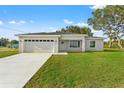 Inviting single-story home with well-kept lawn, featuring an attached two-car garage at 269 Marion Oaks Golf Way, Ocala, FL 34473