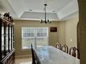 Elegant dining room featuring decorative tray ceiling and large table, ideal for Gathering gatherings and dinner parties at 5765 Sw 164Th Pl, Ocala, FL 34473