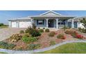 Charming single-story home with a colorful landscaped front yard and blue exterior at 8107 Sw 92Nd Cir, Ocala, FL 34481