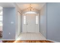 Inviting entryway with tile flooring, decorative sidelights, and chandelier at 8231 Sw 108Th Loop, Ocala, FL 34481