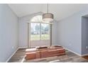 Bright living room featuring a large window, new flooring, and modern light fixture at 8231 Sw 108Th Loop, Ocala, FL 34481