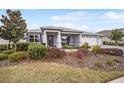 Charming single-story home with manicured landscaping and covered porch at 9270 Sw 89Th Street Rd, Ocala, FL 34481