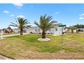 Charming single-story home with well-manicured lawn, beautiful landscaping, and a two-car garage at 9750 Se 179Th Pl, Summerfield, FL 34491