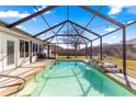 Relaxing screened-in pool featuring a water feature, and ample space for entertaining at 10100 Se 69Th Ave, Belleview, FL 34420