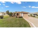 Charming single-story home featuring a well-manicured lawn and two-car garage at 1029 Sw 157Th Ln, Ocala, FL 34473