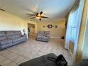 Spacious living room featuring tile floors, neutral walls, and comfortable seating at 13718 Sw 40Th Cir, Ocala, FL 34473