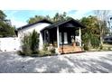 Inviting home exterior with manicured landscaping and a covered porch at 1655 Sunnyside Dr, Maitland, FL 32751