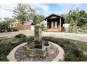 Charming home with a beautifully landscaped front yard and decorative fountain feature at 1655 Sunnyside Dr, Maitland, FL 32751