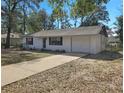 Inviting one-story home with attached garage and a concrete driveway at 18 Juniper Pass Crse, Ocala, FL 34480