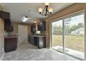 View of the kitchen with dark wood cabinets and large sliding glass doors to the backyard at 23293 Nw Mallard Ave, Dunnellon, FL 34431