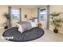 Bright bedroom featuring neutral decor, large windows, and a patterned rug at 434 Bar Ct, Kissimmee, FL 34759