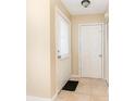 Bright foyer featuring neutral walls, tile flooring, and a front door with blinds at 434 Bar Ct, Kissimmee, FL 34759