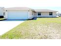 Single-story home displaying attached two-car garage and neutral color palette in a well maintained lawn at 434 Bar Ct, Kissimmee, FL 34759