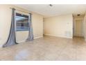 Bright living room featuring tile floors, neutral colored walls, and large window providing ample natural light at 434 Bar Ct, Kissimmee, FL 34759