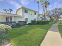 Condominium exterior showcasing lush landscaping and pedestrian pathway at 527 Midway Dr # A, Ocala, FL 34472