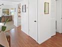 Hallway boasts laminate flooring and white walls, leading to the living area at 527 Midway Dr # A, Ocala, FL 34472