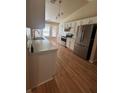 Well-lit kitchen with modern stainless steel appliances, white cabinetry, and a spacious layout at 5305 Se 26Th Ave, Ocala, FL 34480