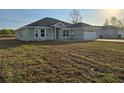 Single story home with a light gray exterior and well-maintained front yard at 5500 Sw 151St Street Rd, Ocala, FL 34473