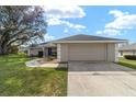 Well-maintained home with attached two-car garage, complemented by a green lawn at 5910 Sw 89Th St, Ocala, FL 34476