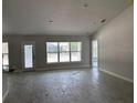 Bright and airy living room showcasing neutral walls, wood-look floors, multiple windows, and recessed lighting at 6644 Sw 179Th Avenue Rd, Dunnellon, FL 34432