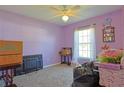 Bedroom with carpeted flooring and a window providing natural light at 6950 Se 124Th Ln, Belleview, FL 34420