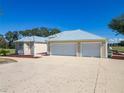 Spacious three-car garage with ample parking and modern exterior design, complementing the home at 7688 Se 135Th St, Summerfield, FL 34491