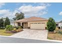 Inviting single-story house boasts a landscaped front yard and a spacious two-car garage with decorative windows at 8532 Sw 79Th Ave, Ocala, FL 34481