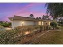 Exterior home view at dusk with lush landscaping and inviting curb appeal at 9126 Sw 102Nd Cir, Ocala, FL 34481