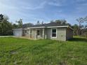 Charming single-story home featuring a front-facing garage and a well-manicured lawn at 96 Fisher Way Trl, Ocklawaha, FL 32179