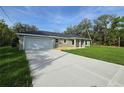 Charming home featuring a front-facing garage and a well-manicured lawn at 96 Fisher Way Trl, Ocklawaha, FL 32179