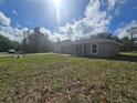 Exterior angle of well-maintained house with green grass, driveway, and a large yard at 96 Fisher Way Trl, Ocklawaha, FL 32179