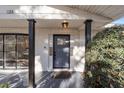 Charming front door entrance with white brickwork, black accents, and a manicured green bush at 1126 Ne 34Th Ave, Ocala, FL 34470