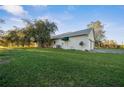 This home features green awnings over a side door, a satellite dish, and a well manicured lawn at 6890 Nw 21St St, Ocala, FL 34482