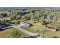 Aerial view of the home nestled within a large, tree-filled property at 7010 Nw 44Th Ave, Ocala, FL 34482