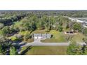 Expansive aerial view of the home showcasing its spacious lot surrounded by lush greenery at 7010 Nw 44Th Ave, Ocala, FL 34482