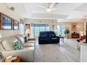 Bright and airy living room features high ceilings, neutral paint, wood-look flooring, and comfortable seating at 7340 Sw 111Th Ln, Ocala, FL 34476