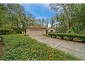 Well-kept home featuring an attached two-car garage, tidy landscaping, and a long, inviting driveway at 7810 Sw 186Th Cir, Dunnellon, FL 34432